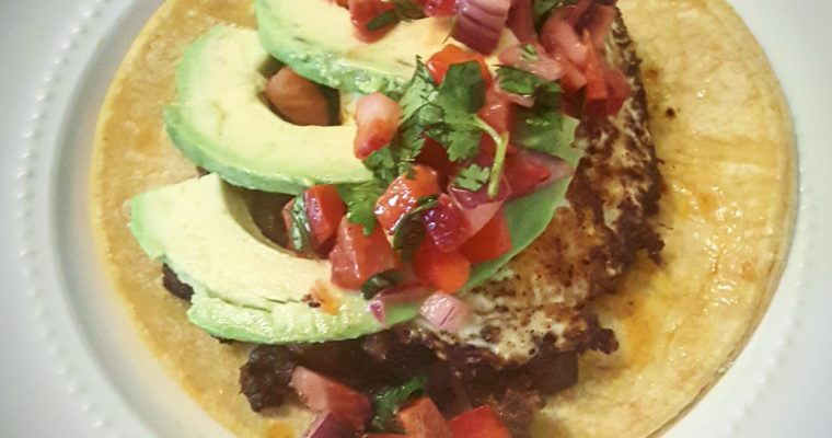 Brunch tacos with chorizo, fried egg, avocado, and strawberry pico de gallo